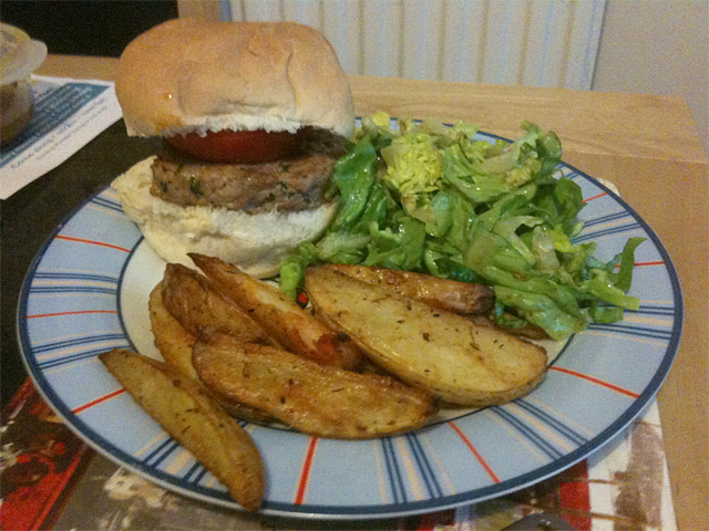 turkey burger with spicy potato wedges and caesar salad