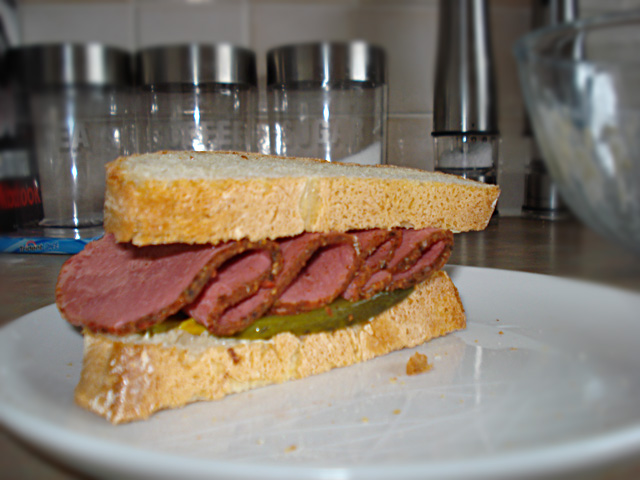 pastrami sandwich with pickle and mustard mayo