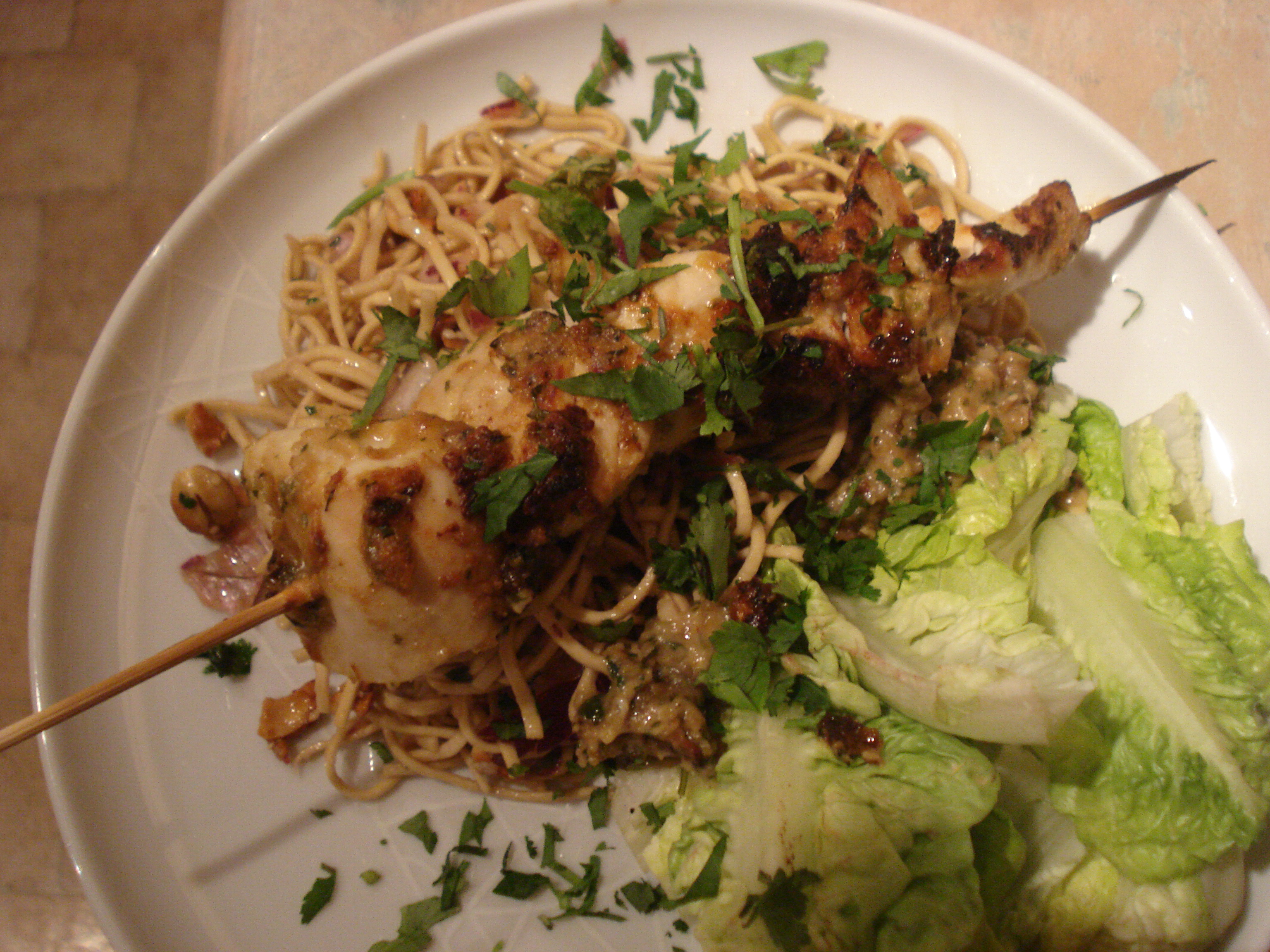 chicken skewers with satay sauce and noodle salad
